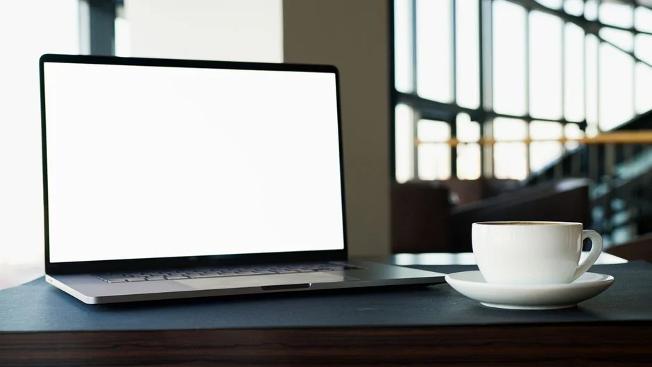 A minimalist desk setup featuring dual monitors, keyboard, mouse, and notebook for productivity.