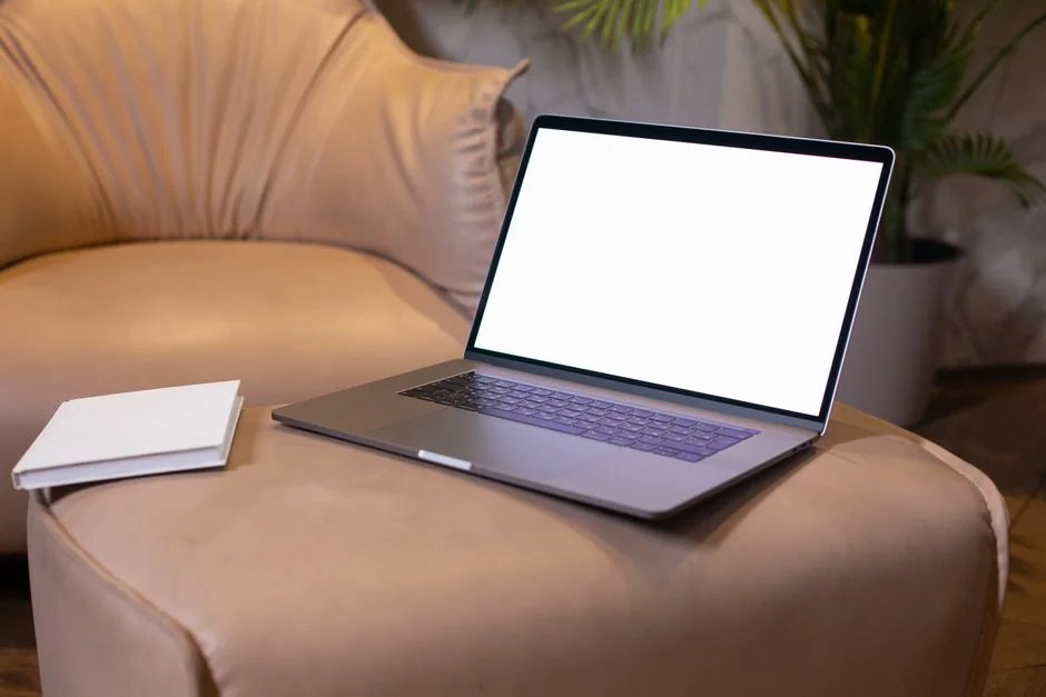 A sleek office desk setup featuring Apple devices: iMac, MacBook, and iPad.